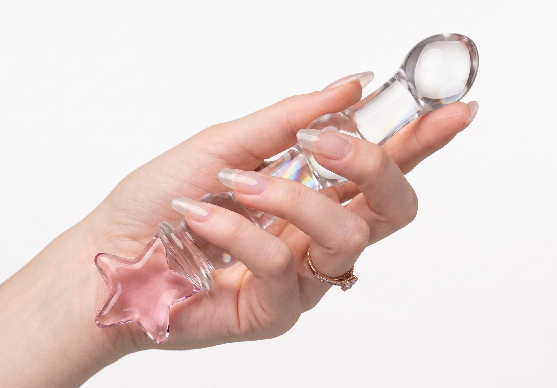 Hand holding the magical girl star glass wand upside down  against a clean white background.