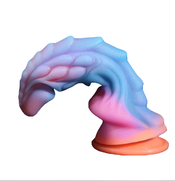 The pastel fantasy dragon dildo bent forward, demonstrating its flexible, body-safe material and strong suction base.