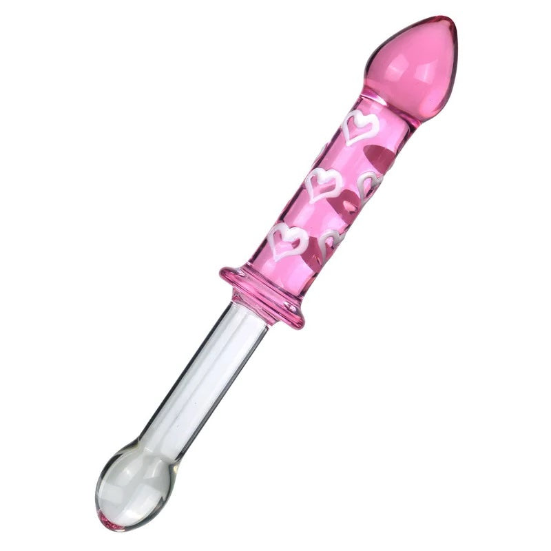 Diagonal view of a double ended borosilicate glass dildo featuring a pink shaft with white hearts on one side and a clear smooth shaft on the other.