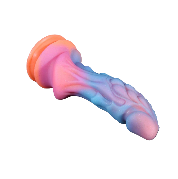 The pastel fantasy dragon toy resting diagonally, highlighting the full length of its textured shaft.