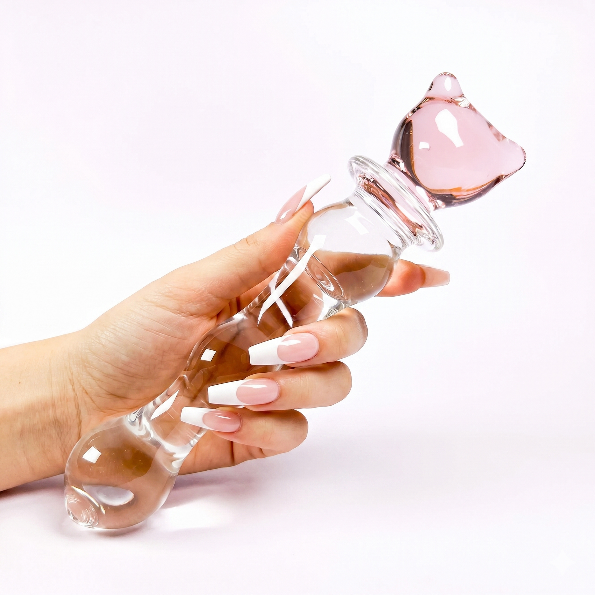 Hand gently gripping the kawaii pink kitty glass wand, showcasing its perfect size and shape for temperature play.