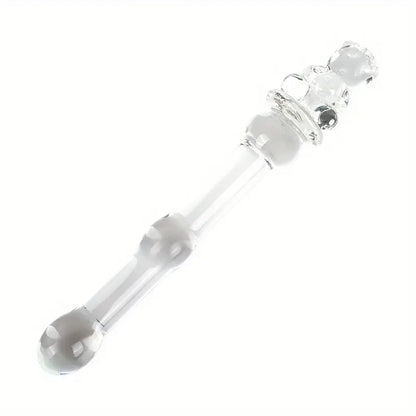 Diagonal view of a petite clear glass pleasure wand with a teddy bear handle on a plain white background.