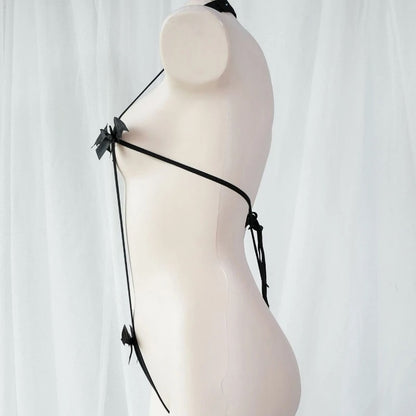 Side angle of an adjustable black elastic monokini harness featuring cute bat and bow details. Alternative goth lingerie