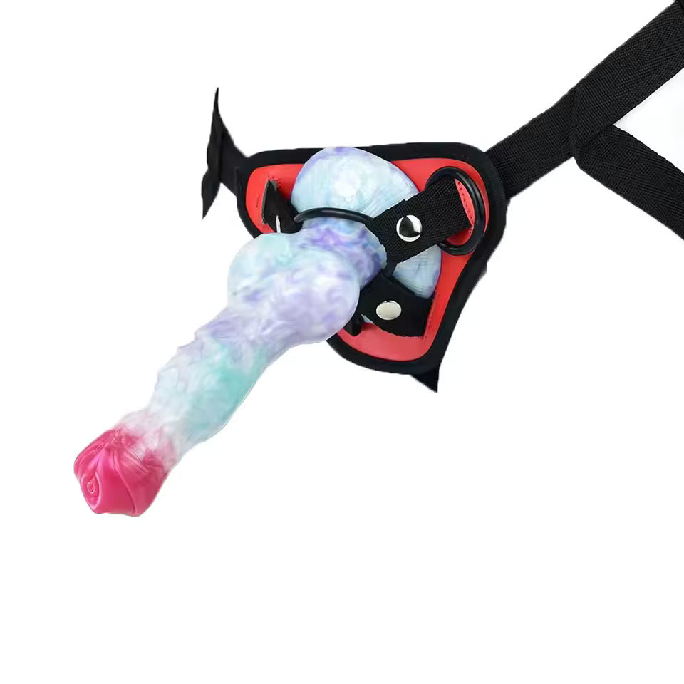 Pastel galaxy swirl fantasy knot dildo attached to a black O-ring strap-on harness for couples pegging play.