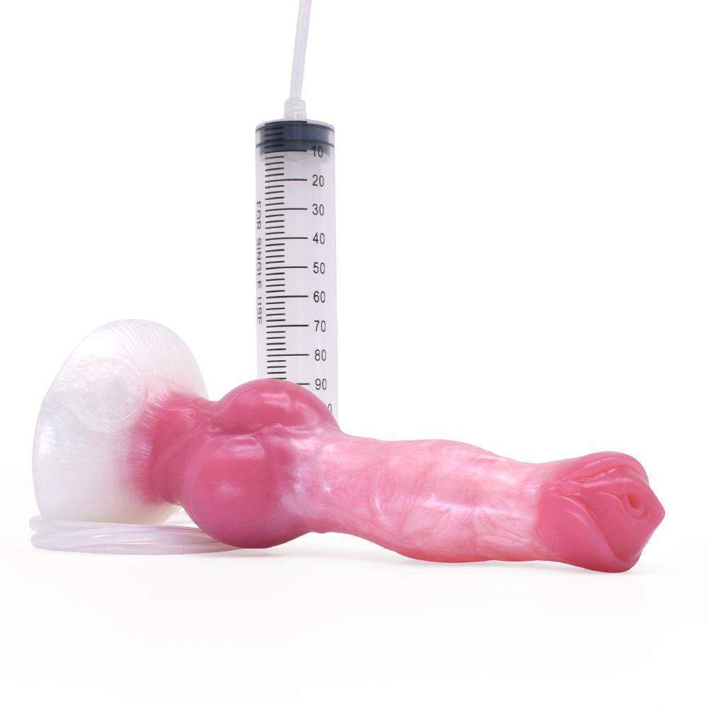 Pink and white strawberry milk marbled squirt dildo lying down with the syringe tube attached to the base.
