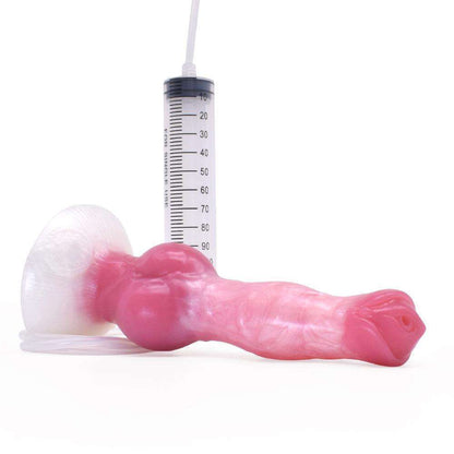 Pink and white strawberry milk marbled squirt dildo lying down with the syringe tube attached to the base.