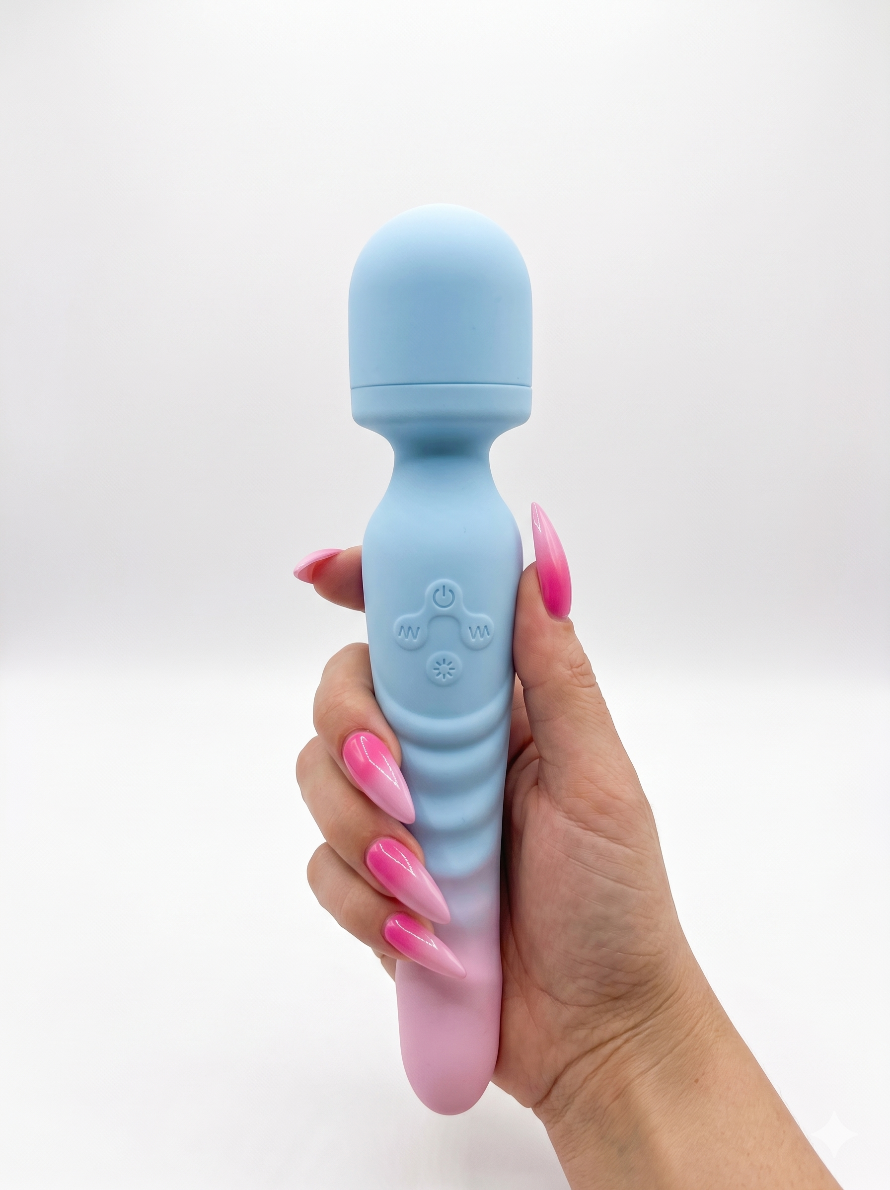 A hand with long pink stiletto nails holds the blue and pink Sweet Surrender vibrator completely vertically against a white background.