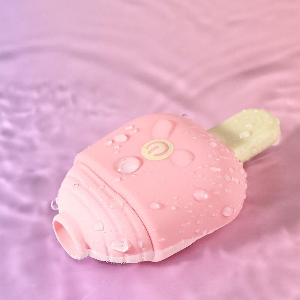 The pastel pink ice cream air-pulse toy resting on its side in clear rippling water against a purple and pink background, demonstrating its splash-proof feature.