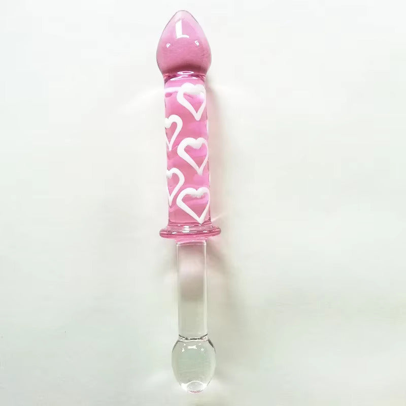 Straight vertical shot of the dual-sided glass dildo against a white background, highlighting the raised white hearts on the pink end.