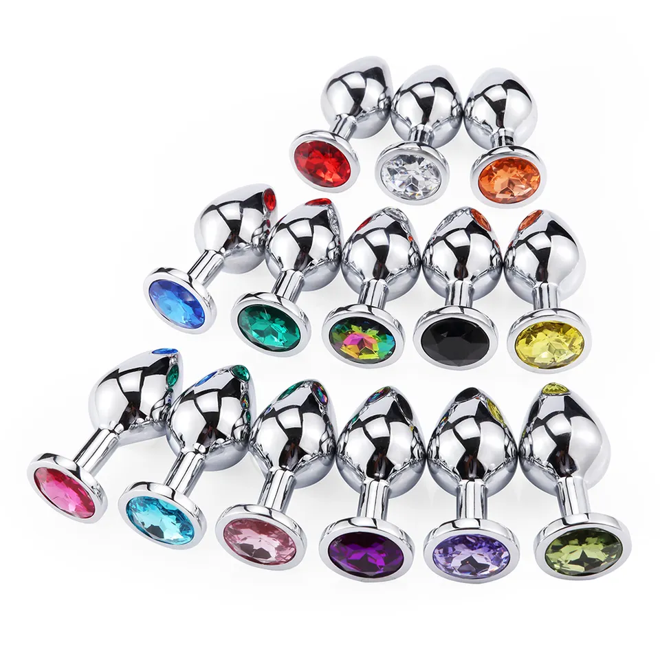 A clustered collection of highly polished stainless steel plugs featuring an array of vibrant, colorful crystal bases.