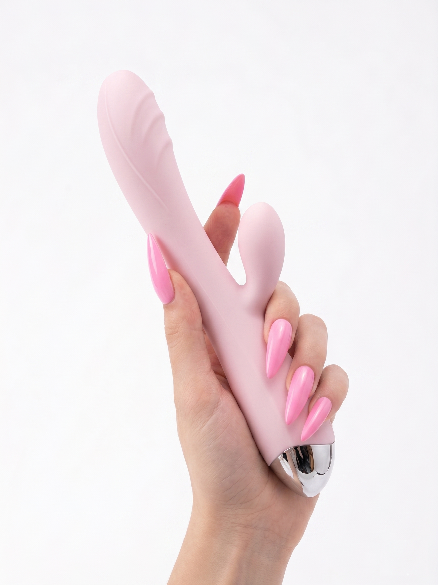 A hand holding the baby pink Pastel Dream Rabbit Vibrator upright, emphasizing the curved shaft for G-spot stimulation and ergonomic shape.