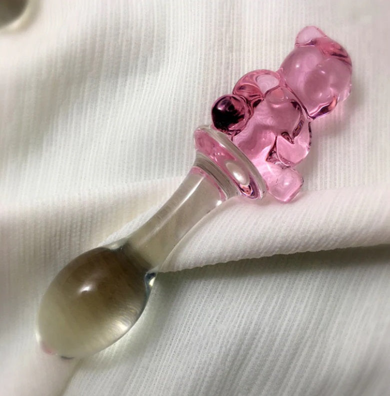 Close-up detail of a pink glass gummy bear sitting on the safety flange of a Kawaii aesthetic toy