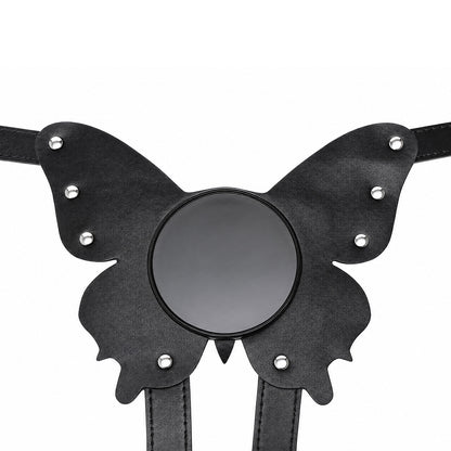 The solid front plate of the black butterfly suction cup harness laid flat, showing the smooth center base designed for secure toy attachment and silver stud detailing.