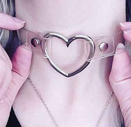 A model wearing a transparent clear PVC heart choker with a silver metal ring.