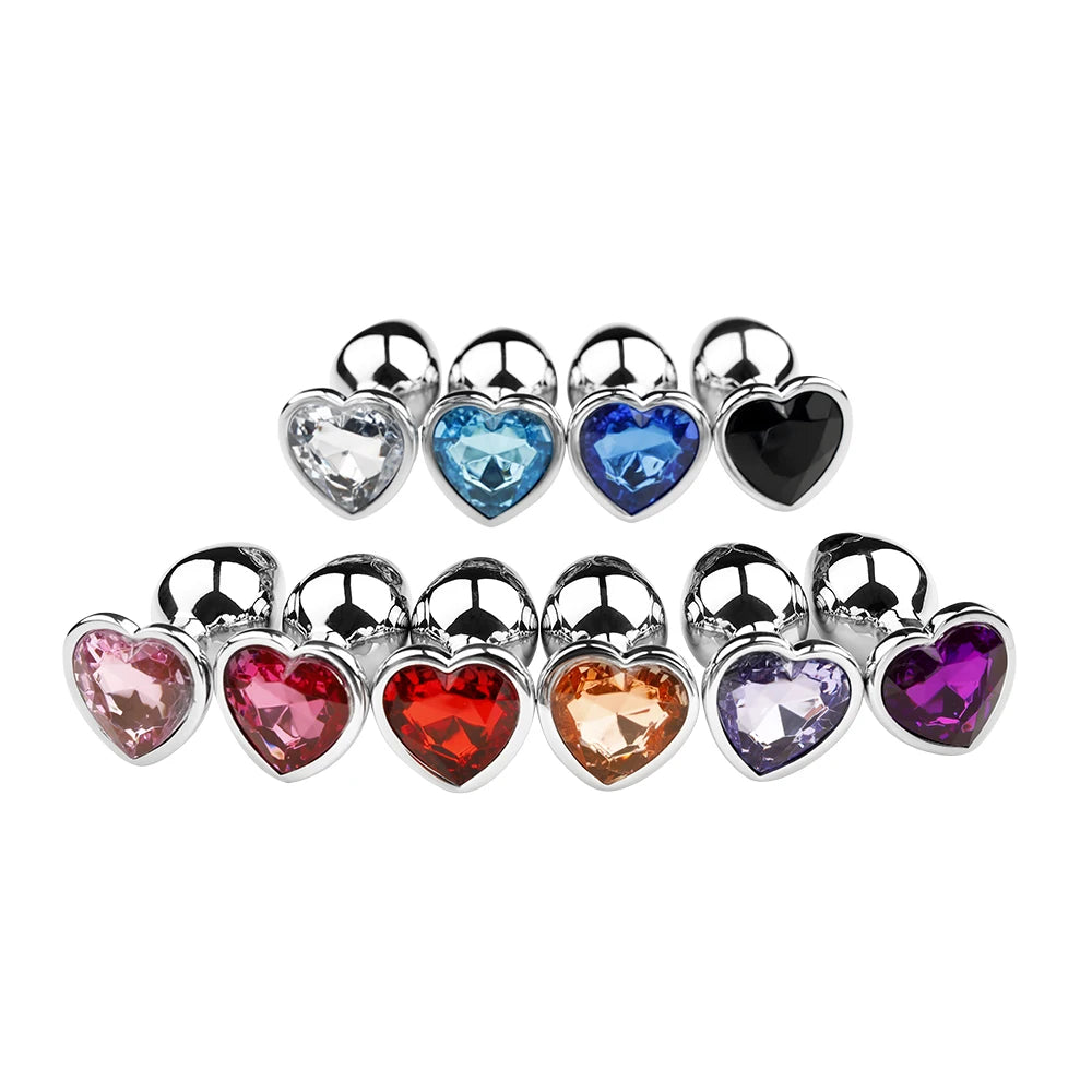 A vibrant collection of crystal heart stainless steel plugs featuring various beautifully colored gemstone bases on a white background.