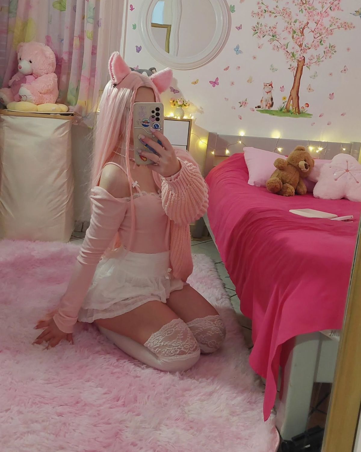 Wide lifestyle shot of a girl in an aesthetic pink bedroom wearing kawaii pet play accessories.