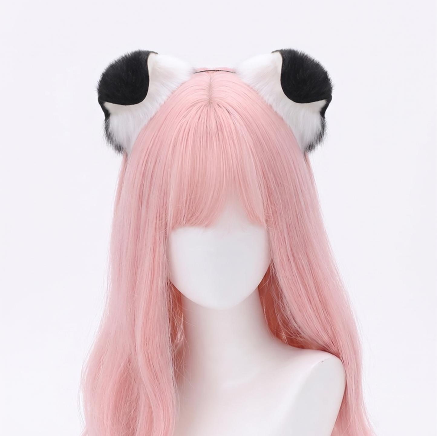 Mannequin head with pastel pink hair modeling a pair of ultra-soft white faux fur puppy ears featuring contrasting solid black tips attached to a discreet metal headband.