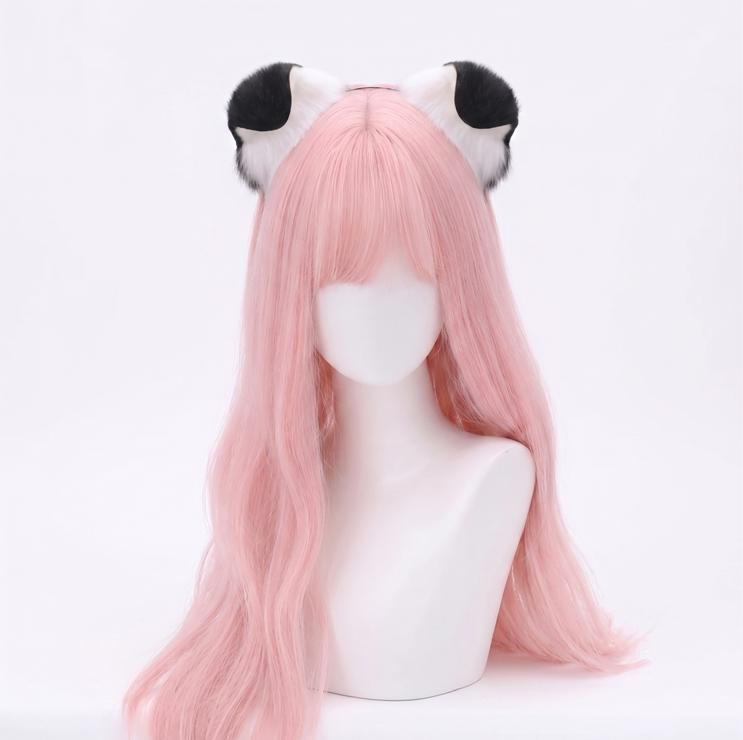 Mannequin head with pastel pink hair modeling a pair of ultra-soft white faux fur puppy ears featuring contrasting solid black tips attached to a discreet metal headband.