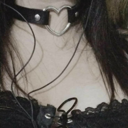 A lifestyle shot of a model in black lace wearing the classic black vegan leather open heart choker.