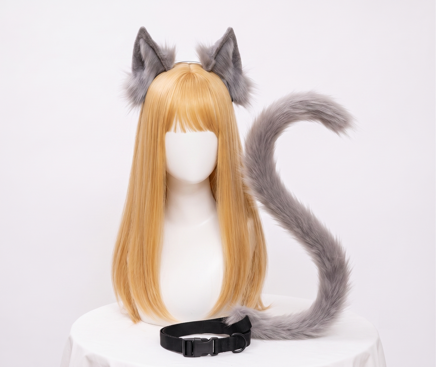 A realistic grey faux fur posable wolf tail and matching ears set displayed beautifully on a mannequin.