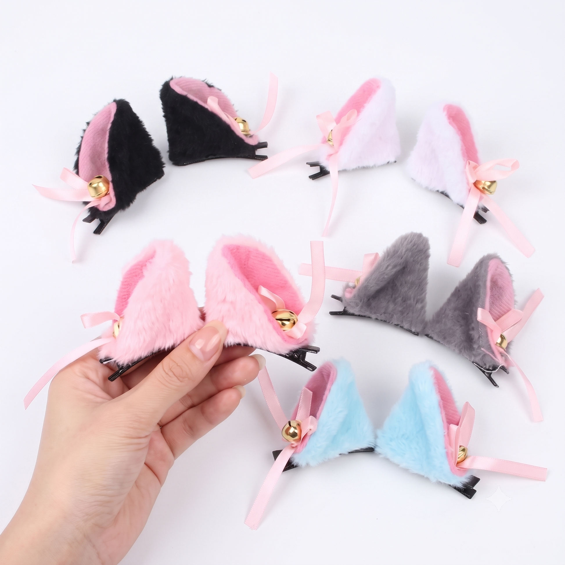 Hand displaying multiple colors of furry cat ear clips with jingling bells.