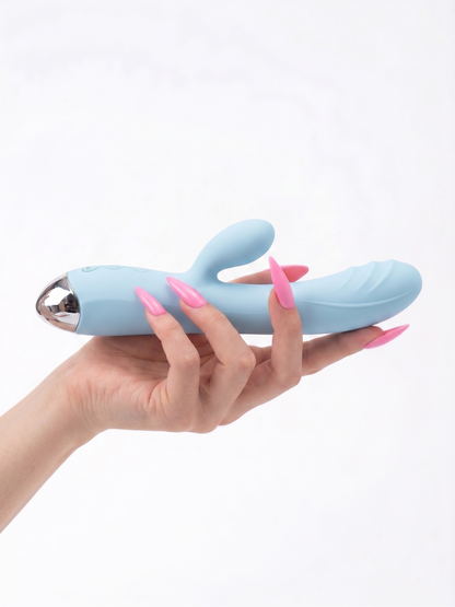 Close-up of a hand holding the aesthetic ice blue Pastel Dream Rabbit Vibrator, highlighting the sleek metallic base and flexible bunny ears.