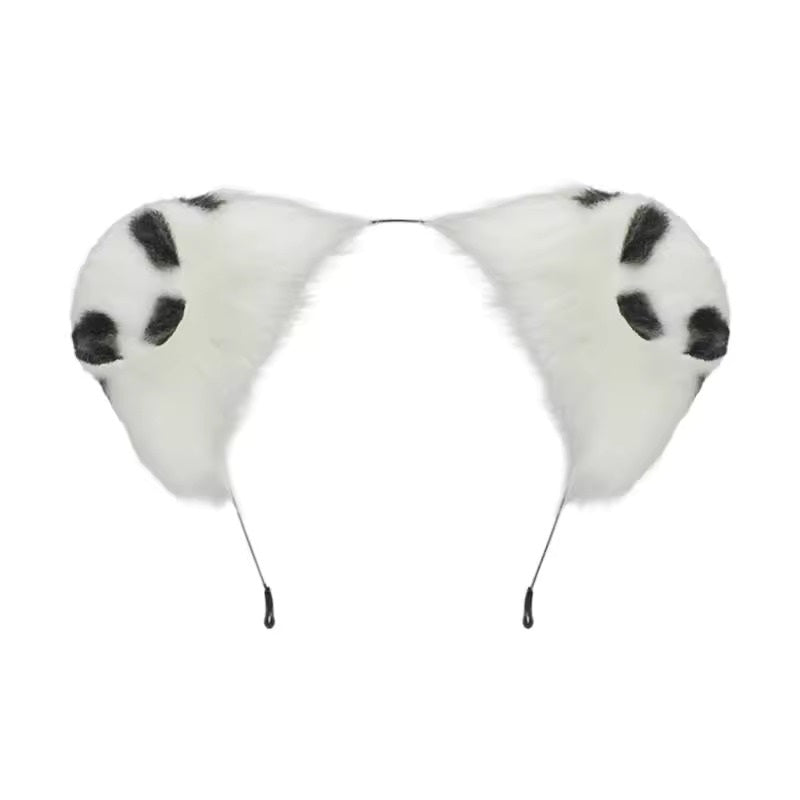 Detailed isolation shot of a thin metal headband featuring two highly textured, fully poseable fluffy faux fur puppy ears with a crisp white base and contrasting black dalmatian spots.