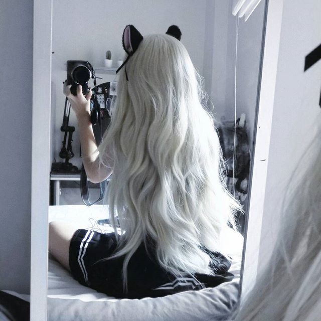 Model with long hair wearing cosplay kitten play ears with cute bows and bells