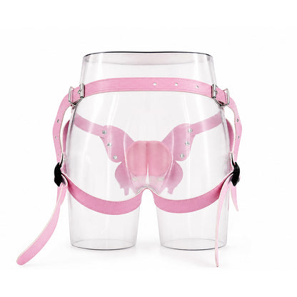 This image shows the back view of the pastel pink vegan leather butterfly harness on a clear mannequin torso. It clearly displays the adjustable waist strap, thigh straps, and metal buckle hardware.