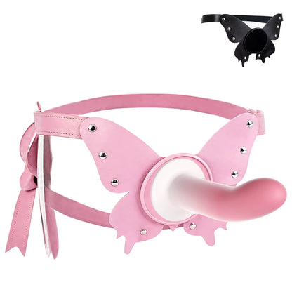 A pastel pink butterfly harness shown with a matching pink suction cup dildo securely attached to its flat universal base, demonstrating how the gear works in practice.