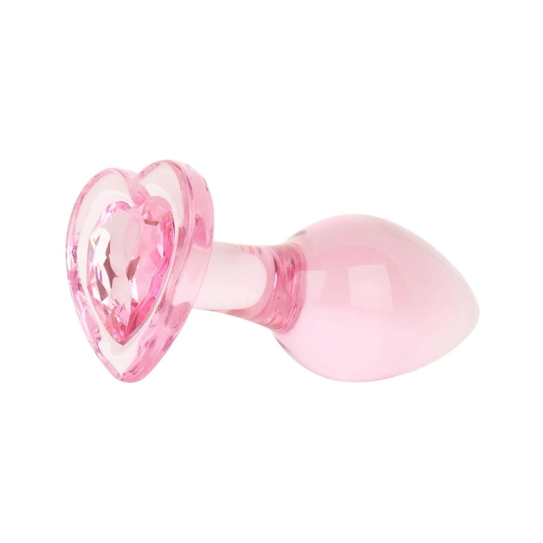 Diagonal view of a translucent pink crystal heart glass plug with a tapered teardrop shape for comfortable insertion.