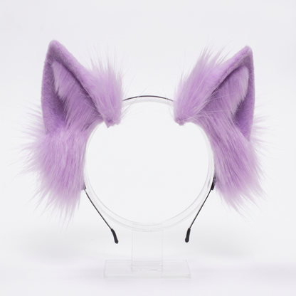 A pair of fluffy purple faux fur cosplay ears attached to a thin, flexible metal headband, isolated on a clean white background.