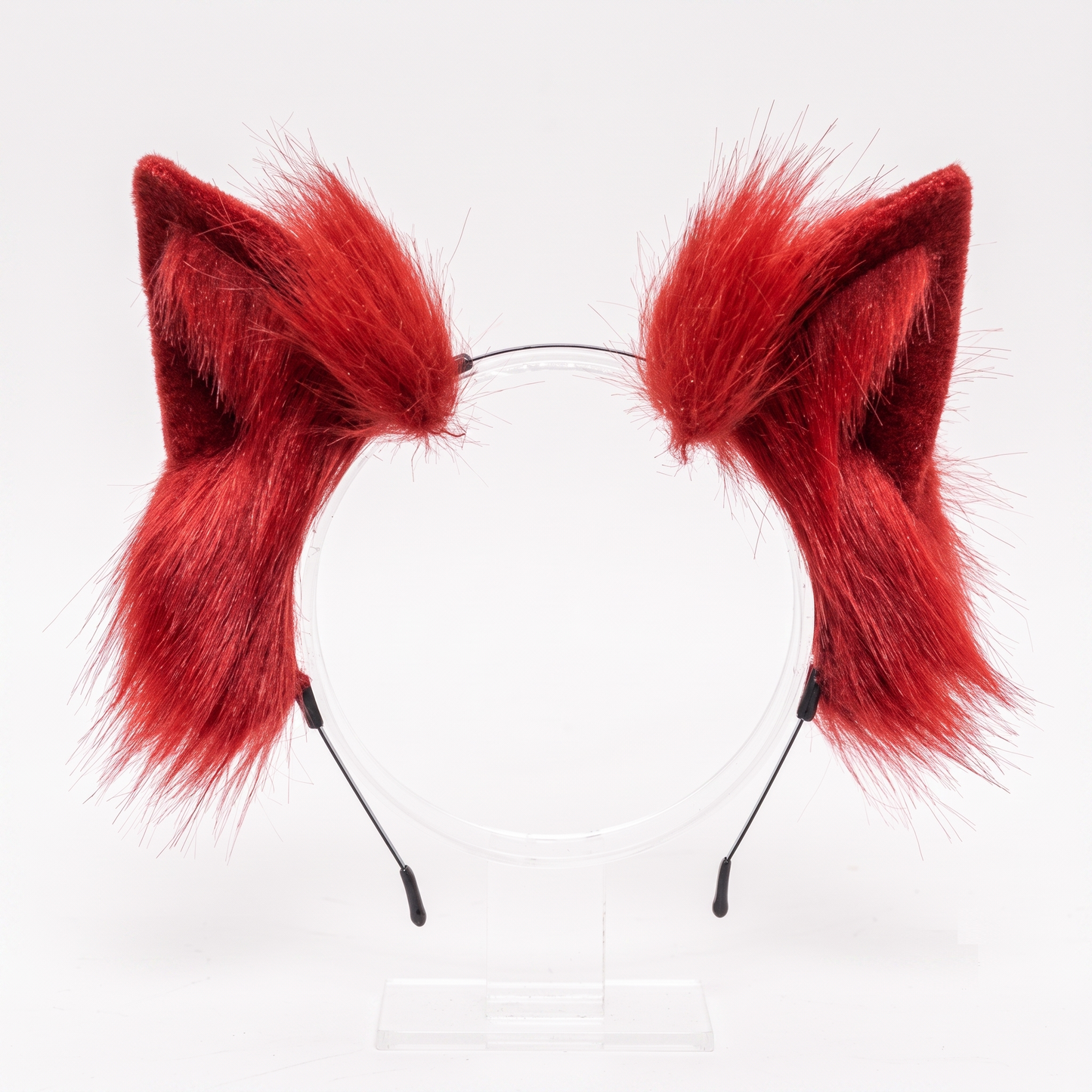 Bright red fluffy faux fur cosplay ears attached to a wire headband, isolated against a pristine white background.