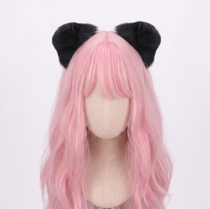 A mannequin styled with pastel pink hair contrasting beautifully against a pair of voluminous, solid black faux fur puppy ears, demonstrating a darker, gothic kawaii aesthetic for pet play enthusiasts.