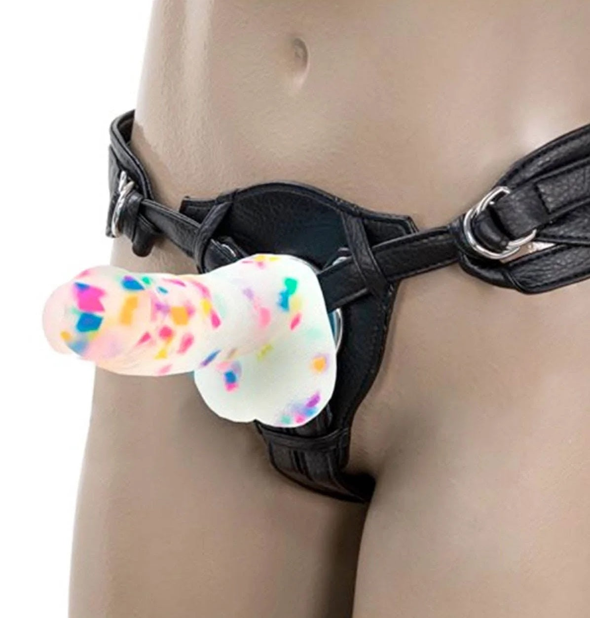 The kawaii confetti silicone dildo securely fitted into a black O-ring strap-on harness, perfect for couples play and pegging.