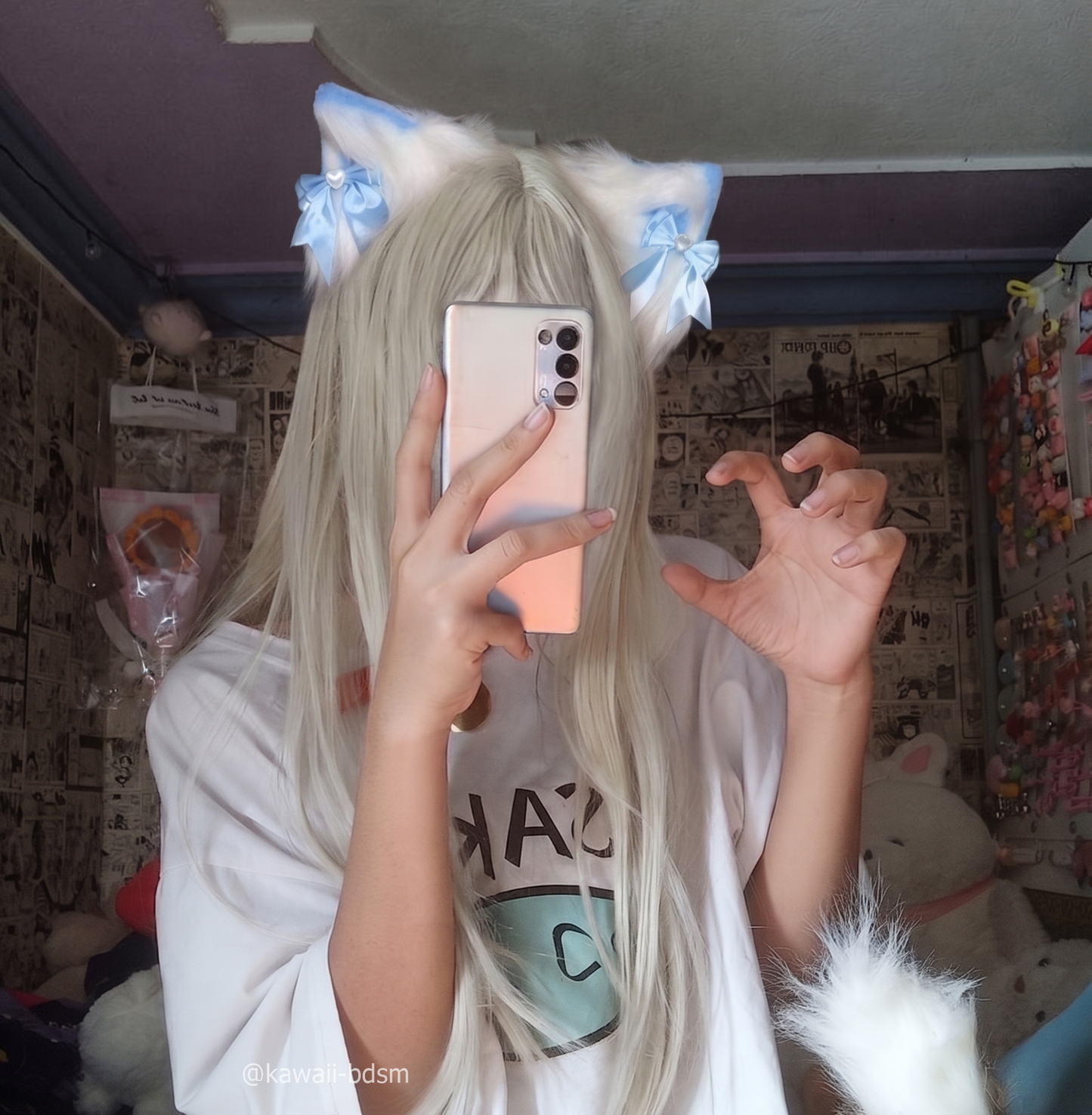 A mirror selfie of a girl with long white hair wearing the pastel blue and white fluffy pet play ear clips, making a playful kitten claw pose with her hands in a cozy bedroom.