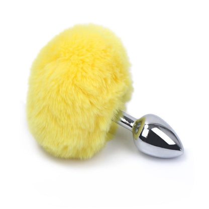A sunny pastel yellow fluffy bunny tail stainless steel plug.