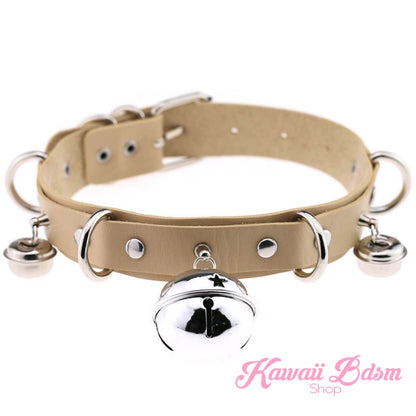 The neutral beige or tan leather cat bell collar variation with shiny silver buckles and a central jingle bell.