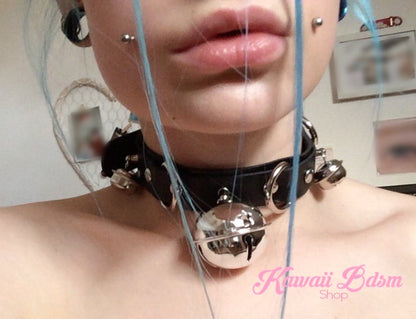 Close-up shot of a model wearing the black leather kitty cat bell collar choker, showcasing its cute alt-fashion and kinky aesthetic.