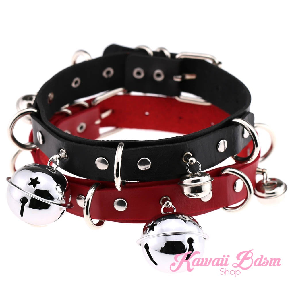 A stack of black leather kitty bell collars featuring an edgy red interior lining and silver hardware.