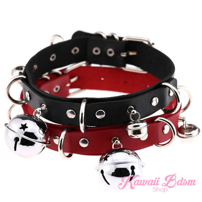 A stack of black leather kitty bell collars featuring an edgy red interior lining and silver hardware.