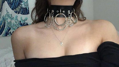 Close-up of a model wearing a black Brat collar, demonstrating the perfect fit and shine of the silver hardware.