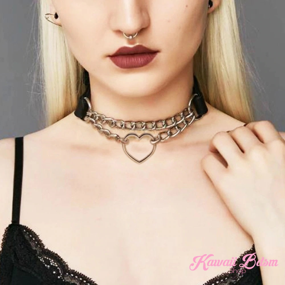 Close-up of a model wearing a layered silver chain heart choker, showcasing a kinky grunge and alt-fashion aesthetic.