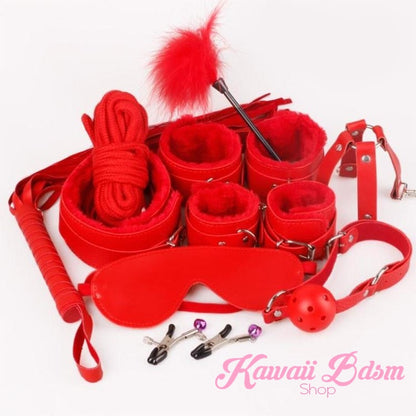 Cherry red complete bondage set displaying furry handcuffs, ankle cuffs, and feather tickler.