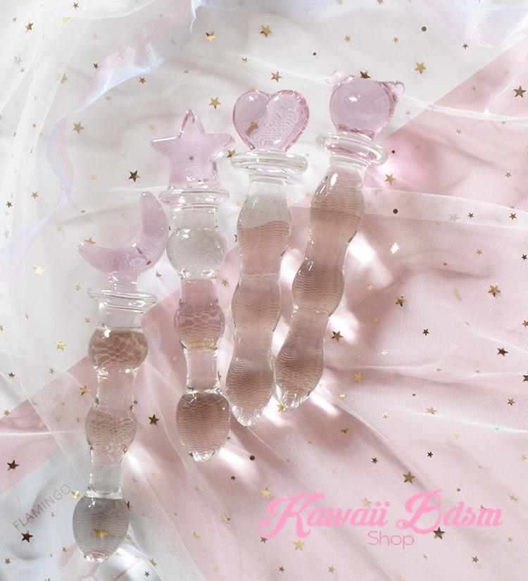Assorted clear glass pleasure wands with pink cat handles displayed beautifully on a dreamy pastel background with aesthetic sparkles.