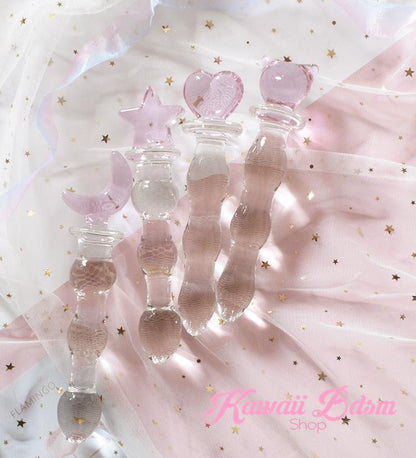 Assorted clear glass pleasure wands with pink cat handles displayed beautifully on a dreamy pastel background with aesthetic sparkles.