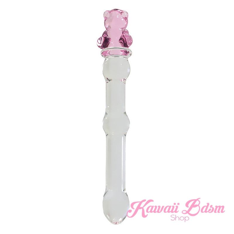 Upright clear borosilicate glass pleasure wand featuring a slim ribbed shaft and an adorable pink teddy bear handle.