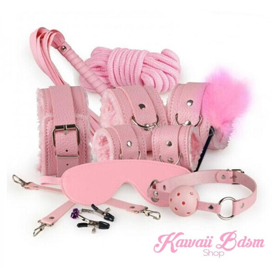 Full layout of the pastel pink 10-piece complete bondage set featuring plush cuffs, rope, and ball gag on a white background.