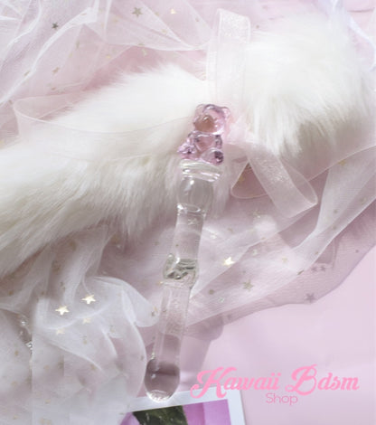 The kawaii pink teddy bear glass pleasure wand resting beautifully on soft white faux fur.