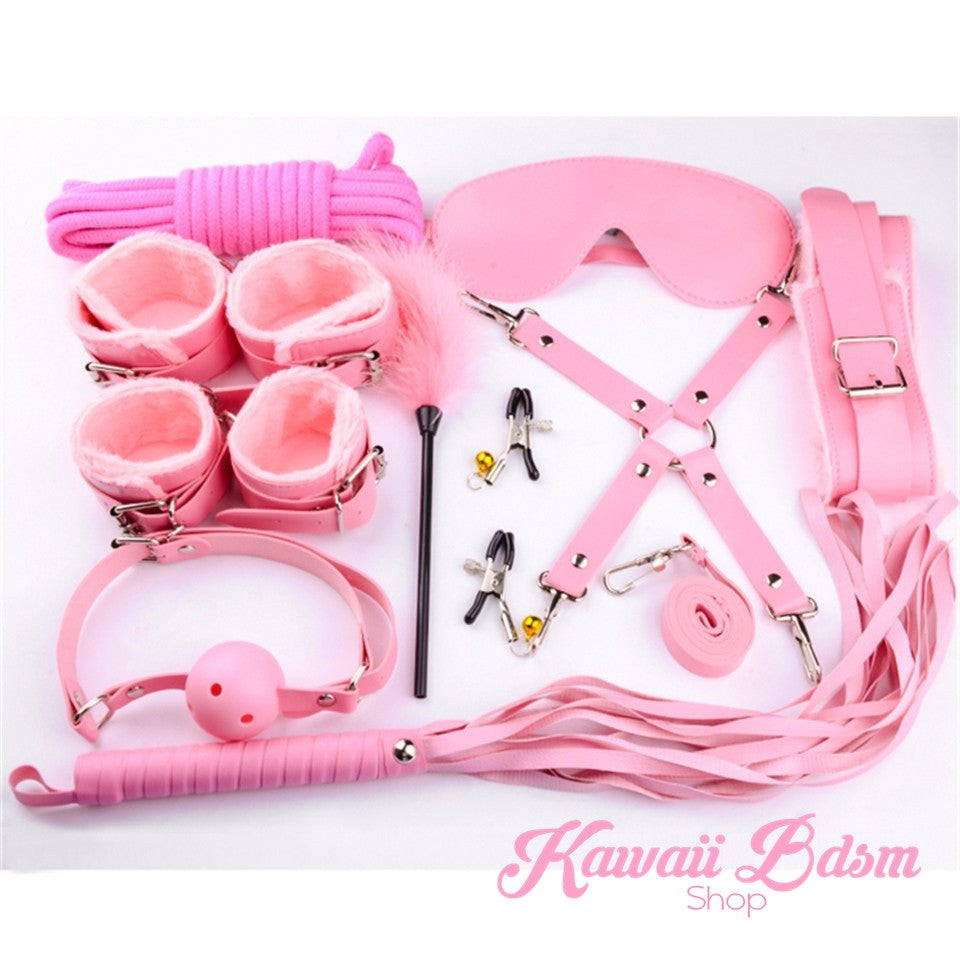 Full pastel pink 10-piece bondage set including the adjustable cross belt, whip, and leash.